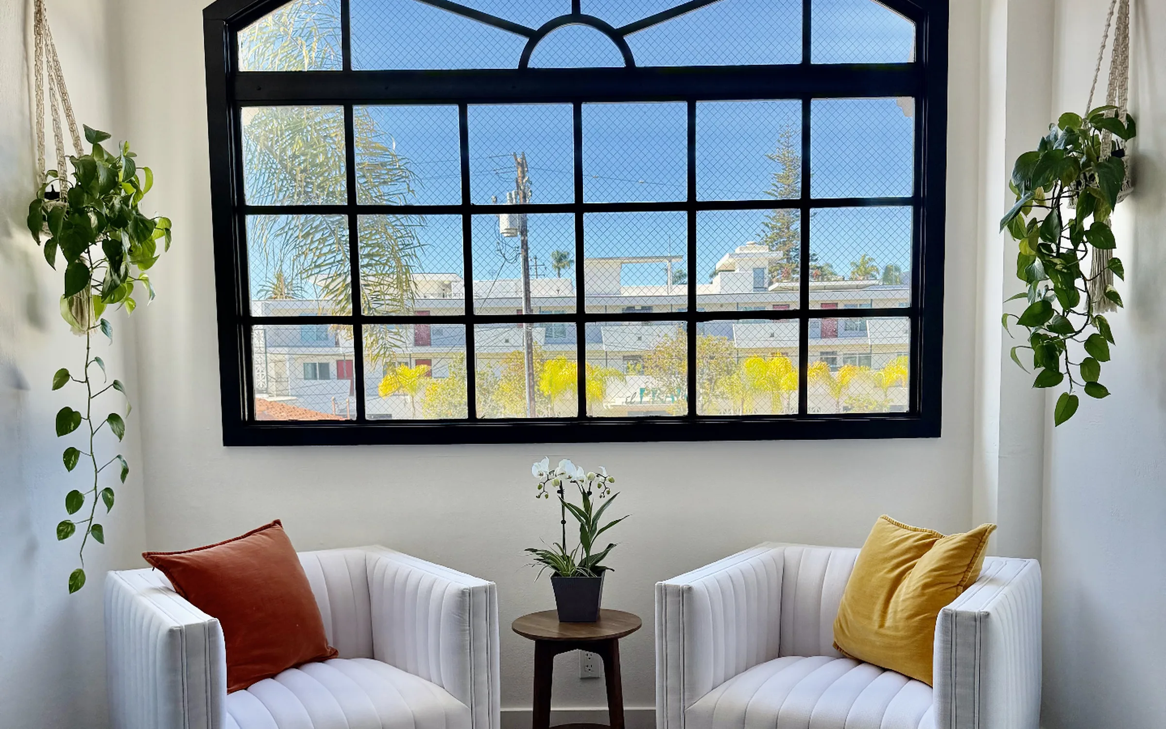Kerfree Aesthetics consultation lounge with arched window and armchairs